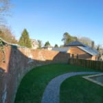 New development of four houses on Kenwyn Church Road. Curved garden wall